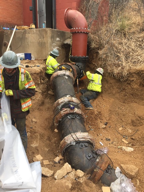 Working on Large Pipe - Home Page Men working on a large pipe in under ground